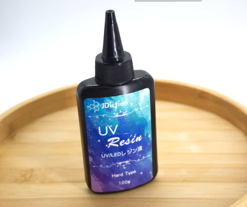 This image shows the UV resin bottle to show how to make polymer clay earrings shiny