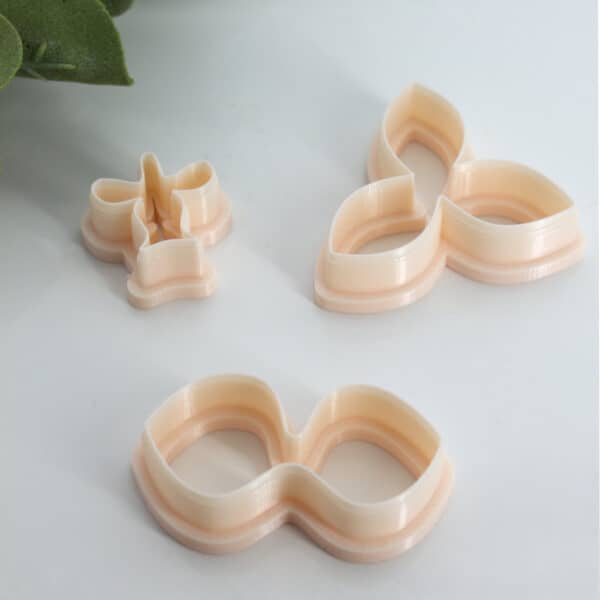 Three-piece clay cutters set designed for crafting intricate orchid-shaped polymer clay creations with ease and precision.