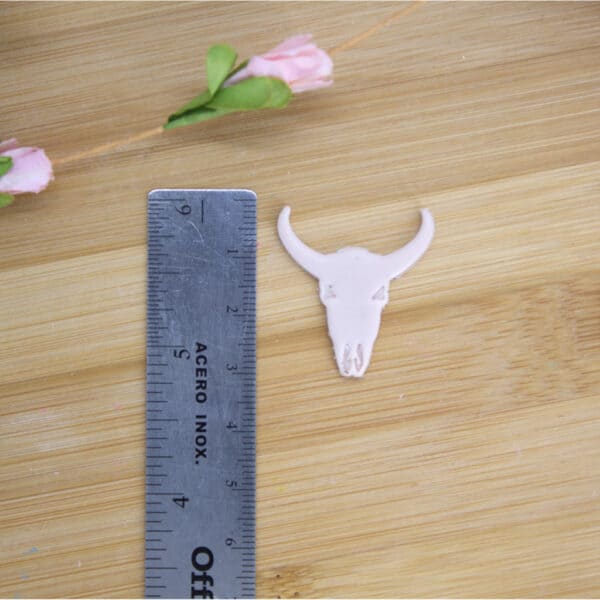 A cow skull-shaped polymer clay cutter, perfect for adding a touch of rustic charm to your creations using innovative polymer clay cutters.