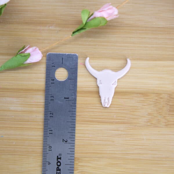 A polymer clay cutter showcasing a cow skull shape, allowing artists to create distinctive and imaginative designs using versatile clay cutters.