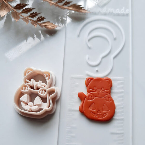 Clay cutters Halloween special: a cat on a pumpkin design, ideal for crafting unique polymer clay earrings