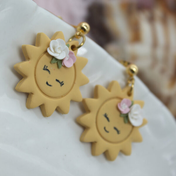 Summer jewelry with a twist - handmade polymer clay earrings with a sun motif.