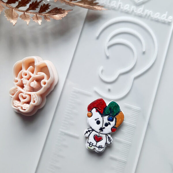 Craft Halloween-themed jewelry using our polymer clay cutter in the shape of a voodoo doll