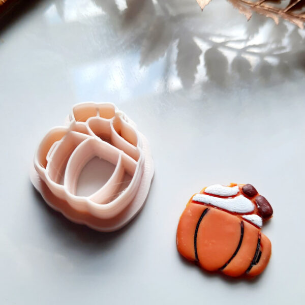 "A vibrant pumpkin polymer clay cutter, perfect for creating Halloween-themed earrings