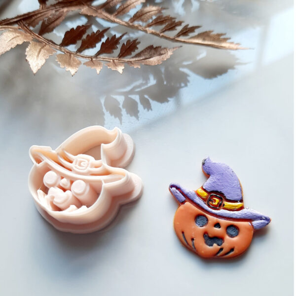 Unique Halloween polymer clay cutter shaped like a pumpkin wearing a hat, perfect for crafting spooky earrings