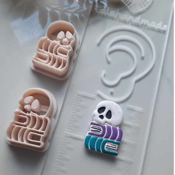 Craft your own eerie Halloween earrings with this skull book-shaped polymer clay cutter