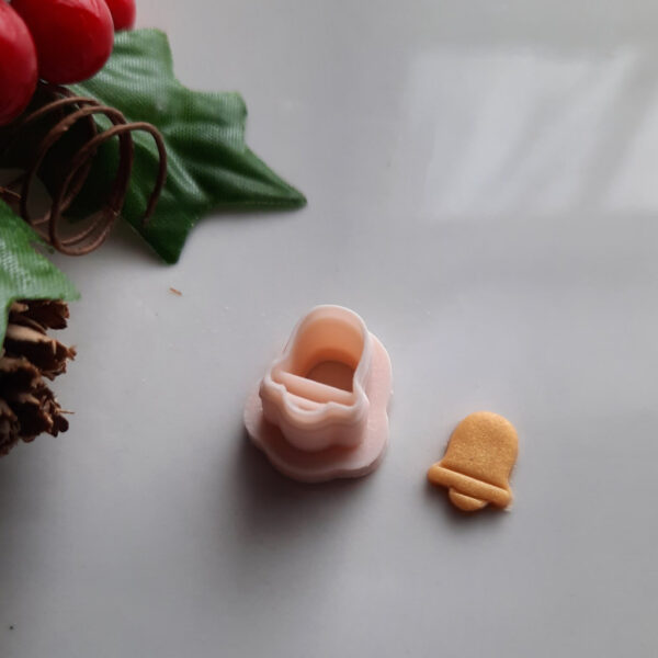 A bell-shaped polymer clay cutter, perfect for crafting festive Christmas-themed earrings