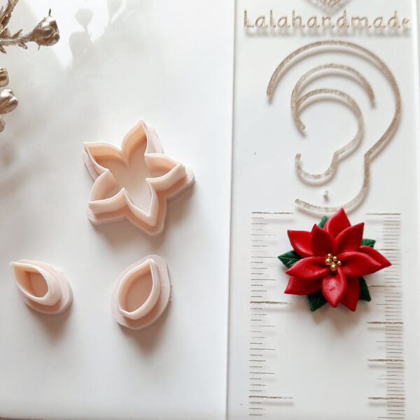 Poinsettia-shaped polymer clay cutter used for creating festive Christmas-themed earrings