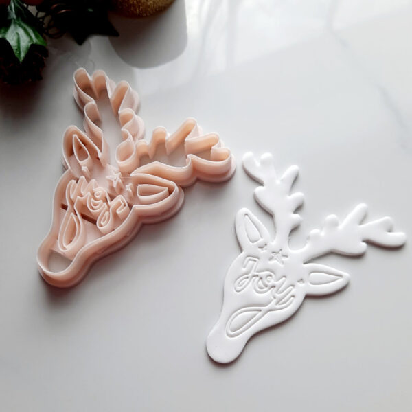 A sharp-edged reindeer-shaped polymer clay cutter for making intricate Christmas ornaments