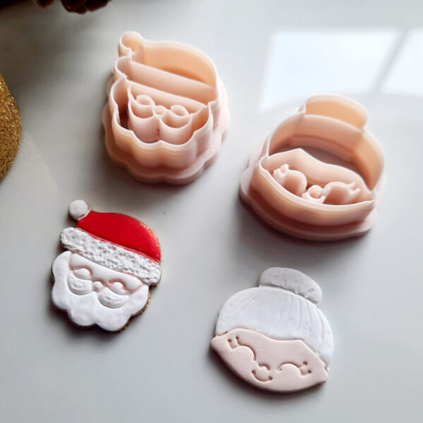 A set of Christmas clay cutters featuring Santa Claus and Mrs. Claus, perfect for crafting holiday-themed polymer clay earrings.