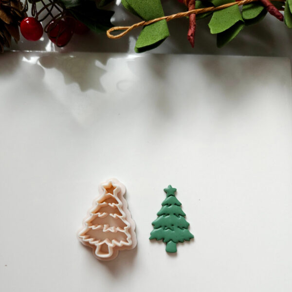 Festive polymer clay cutter shaped as a Christmas tree with a star, ideal for making holiday earrings.