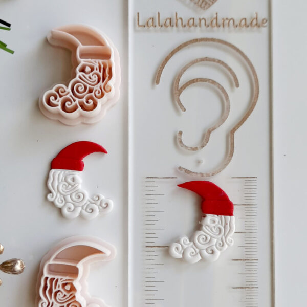 Polymer clay cutter shaped as a Santa Moon for Christmas earring designs.