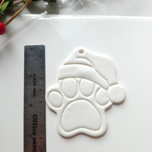 Crafting tool for making Santa Claus dog paw ornaments from polymer clay for the holiday season