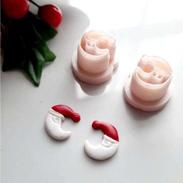 Half-moon polymer clay cutter with a Christmas hat, perfect for crafting festive earrings.