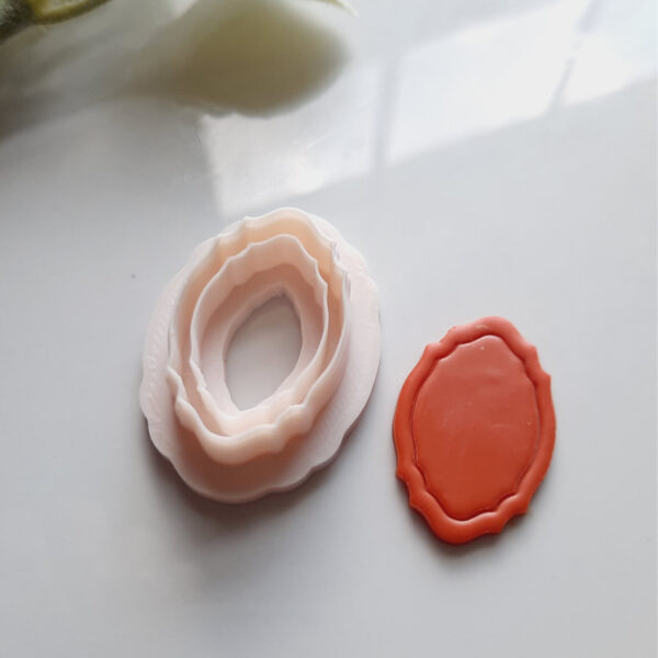 Polymer clay cutter with a unique mirror frame shape, perfect for creating vintage-style earrings.