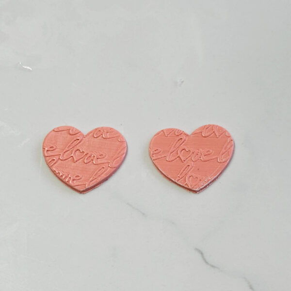 Creating romantic polymer clay earrings using a love letter texture roller pin