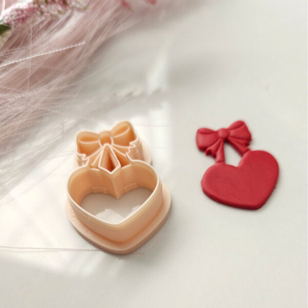 Create romantic earrings for Valentine's Day with this heart and bow polymer clay cutter.