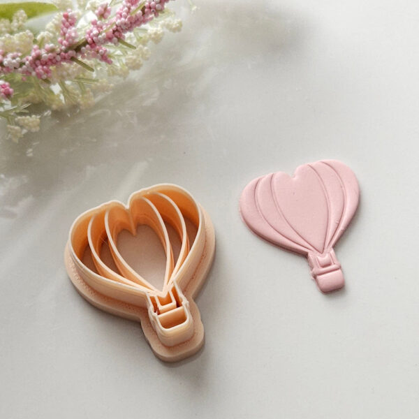 A unique hot air balloon polymer clay cutter designed for creating handmade Valentine's Day earrings