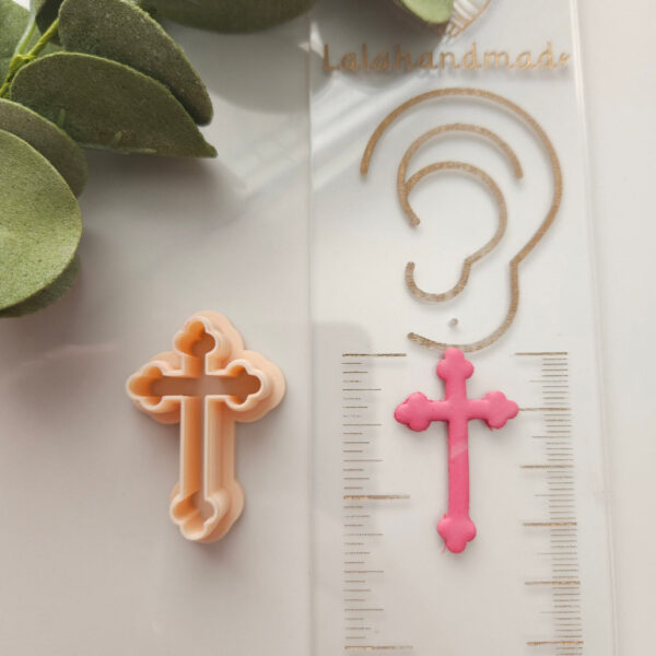 Religious-themed polymer clay cutter used for designing cross-shaped Easter earrings.