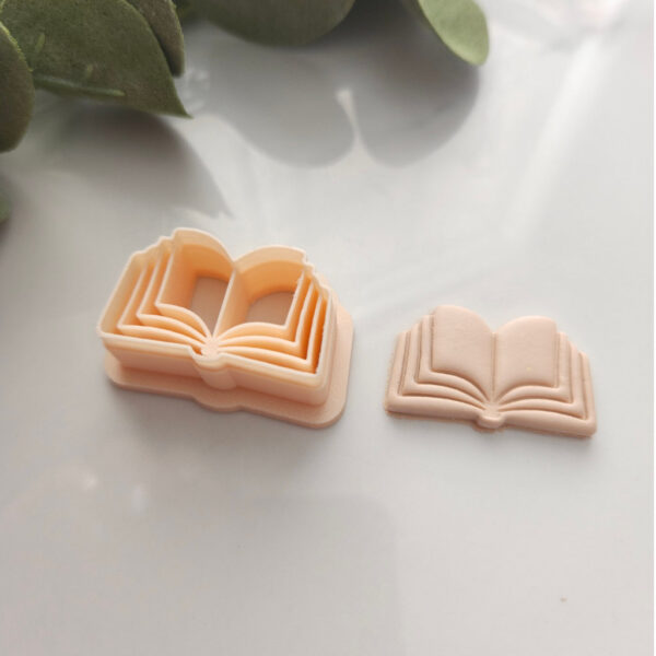 Open Book Clay Cutter used for crafting Polymer Clay Earrings, presented with a leafy scenery