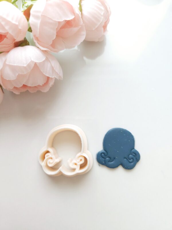 Octopus clay cutter next to a octopus polymer clay earring