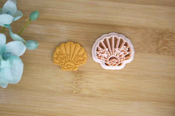 seashell clay cutter with a palm stamp in the middle